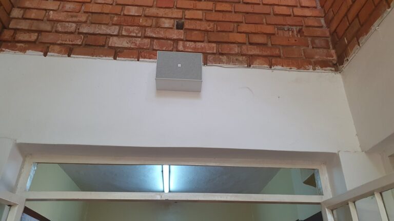 Wall speaker above a classroom door