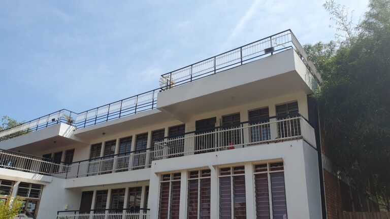 Outdoor speakers on the school rooftop railings