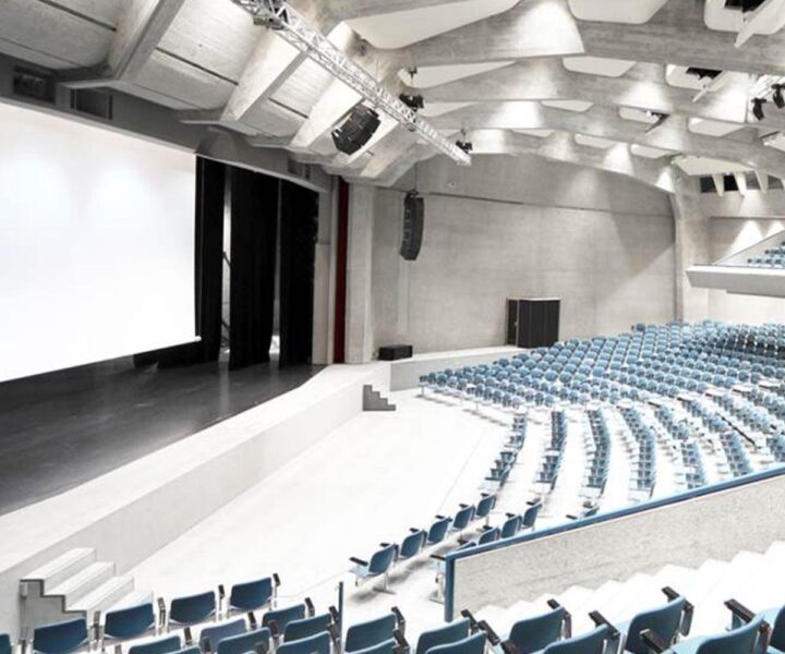 Auditorium with line array sound system and large projection screen