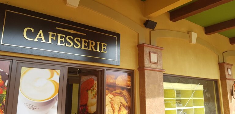 Cafesserie shopfront at Village Mall with wall speaker on the arcade