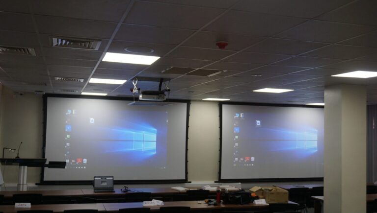 Dual screens with projector on a ceiling lift