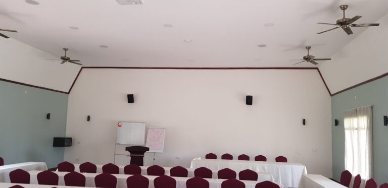 Conference room with wall and ceiling speakers and projector