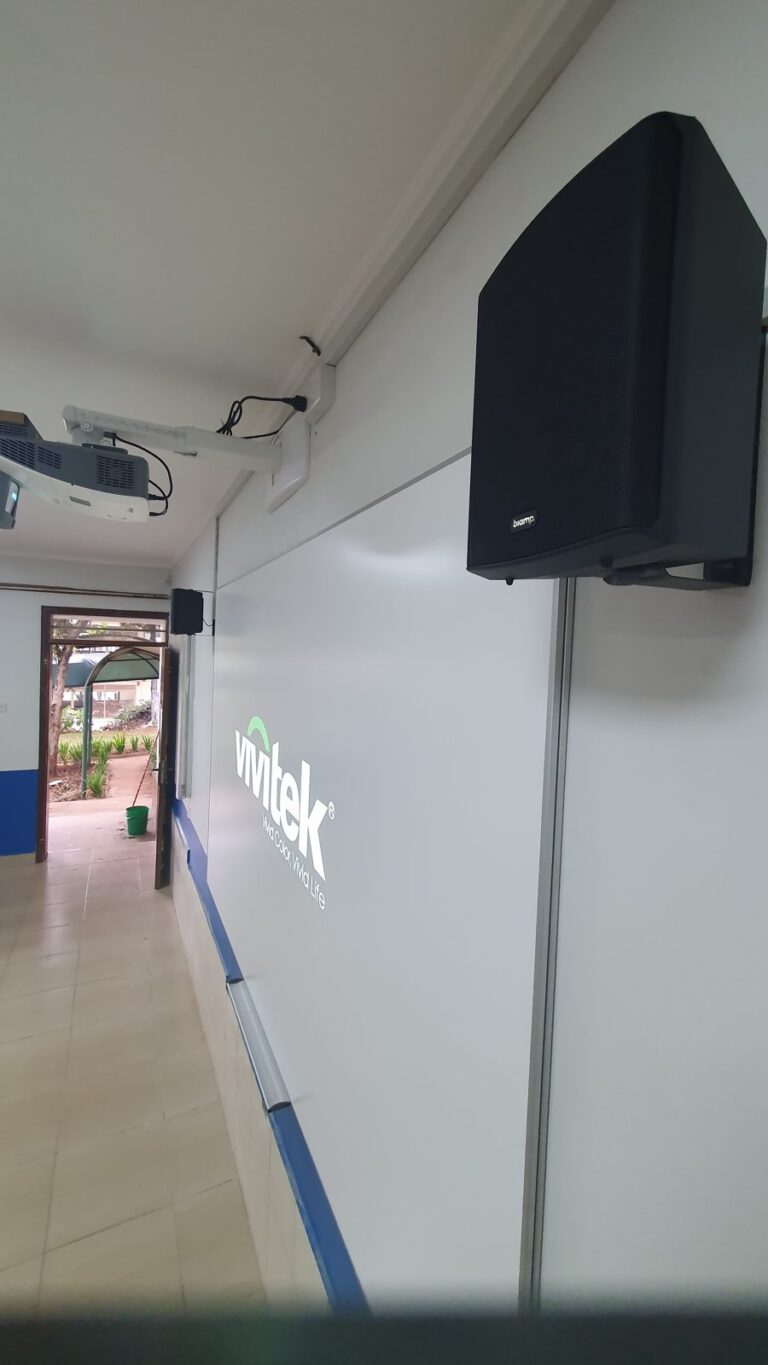 Biamp wall speaker beside the projection board