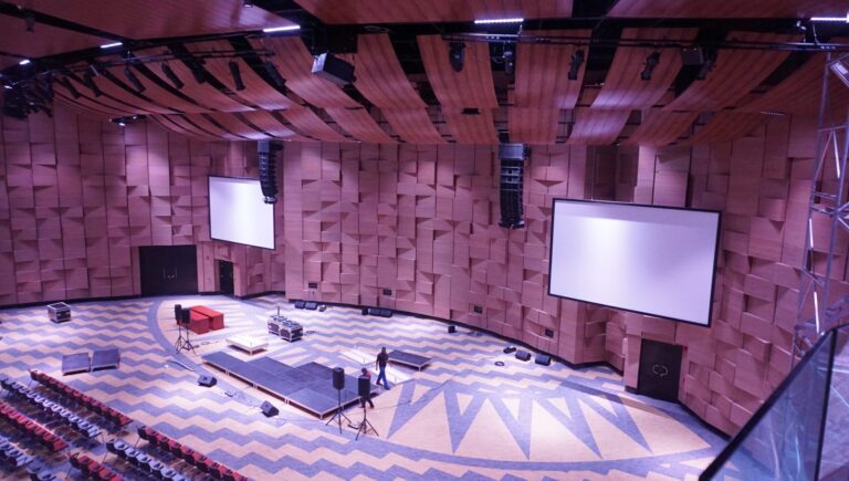 Main hall seen from above showing flown line array speakers