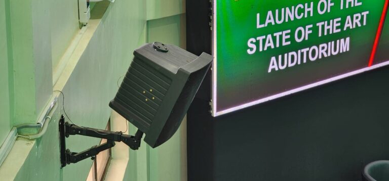 Wall speaker on an adjustable arm bracket next to the LED screen