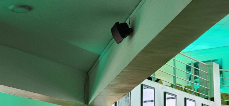 Speaker mounted under the balcony beam