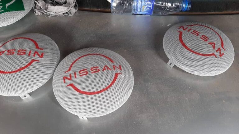Nissan-branded speaker grilles before installation