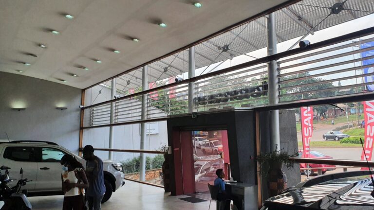 Showroom entrance with speakers above the glass