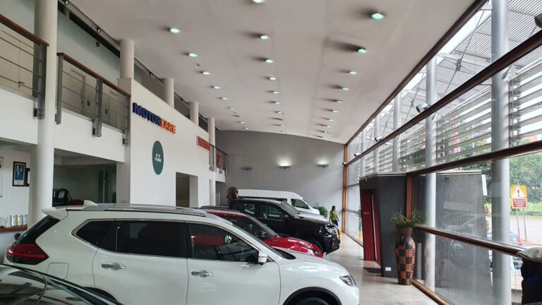 Inside the Nissan Motorcare showroom with speakers along the glass front