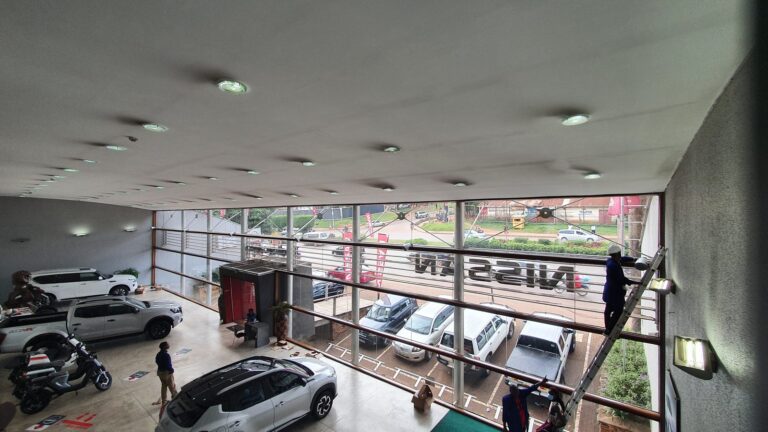 Integrator installing speakers in the Nissan showroom