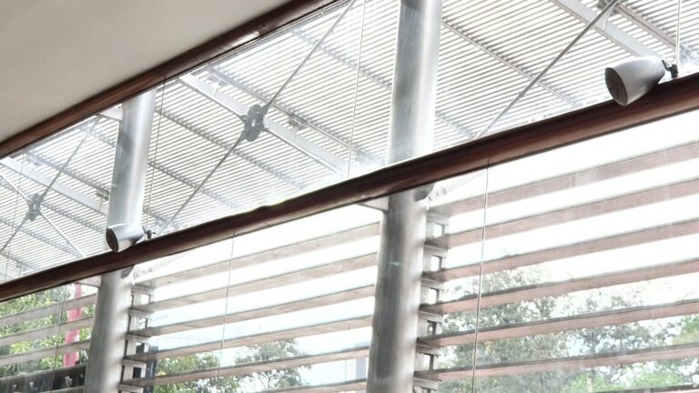 Speakers mounted on the showroom window rail