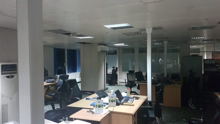 Open-plan office during ceiling speaker installation