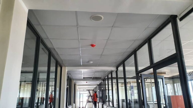 Corridor with ceiling speaker and fire detection devices