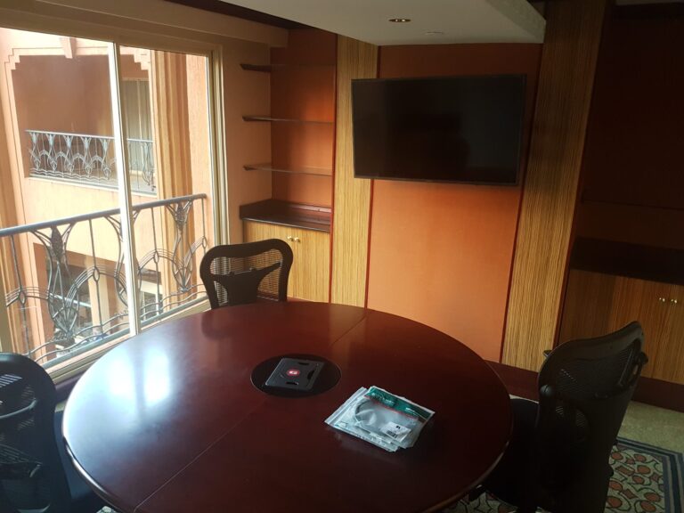 Small round-table meeting room with display