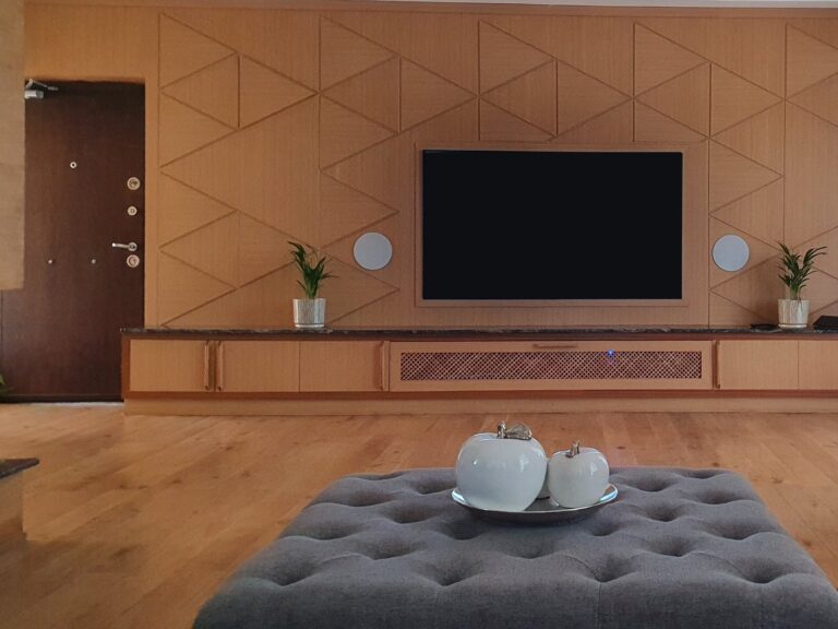 Penthouse living room with in-wall speakers either side of the TV
