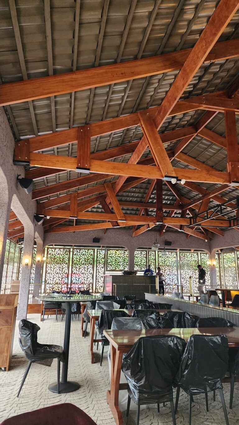 Dining terrace at SOL Kololo under the timber roof with speakers on the walls