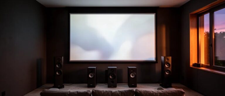 Dedicated home cinema with projection screen and floorstanding speakers