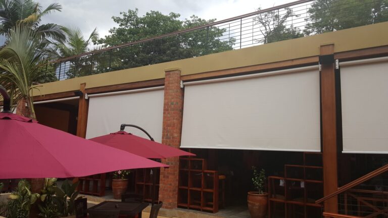 Weatherproof speakers on timber posts above the terrace blinds