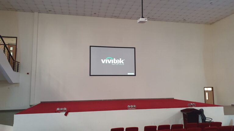 Vivitek laser projector on a ceiling drop pole above the stage