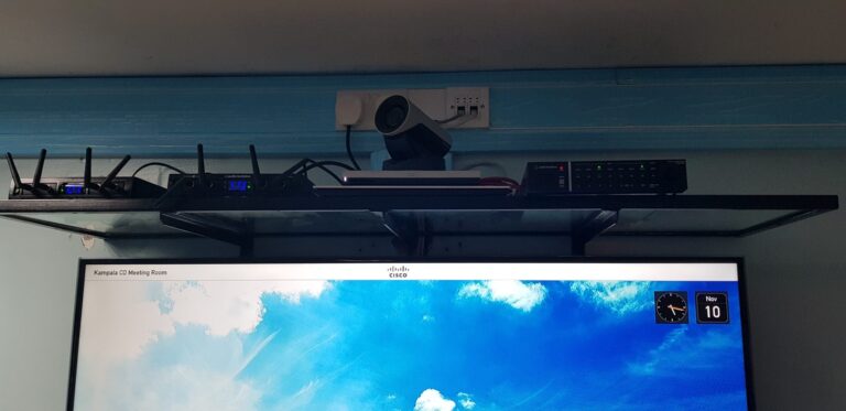 AV shelf with wireless receivers, Cisco camera and Audio-Technica mixer above the display