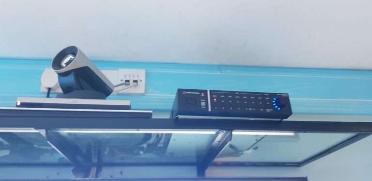 Cisco video conferencing camera next to Audio-Technica digital mixer